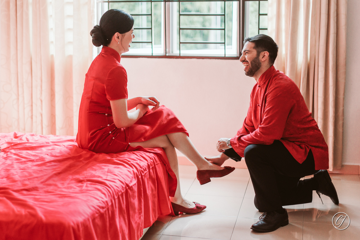 Groom Fartash helping the bride to wear her heels