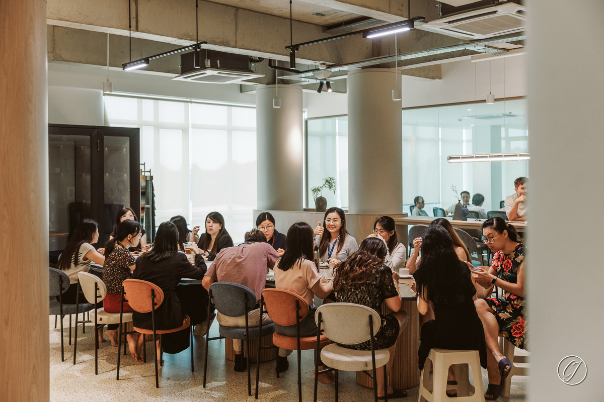 The team and guests enjoying the meal on a shared table