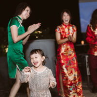Little girl dancing with bride and groom