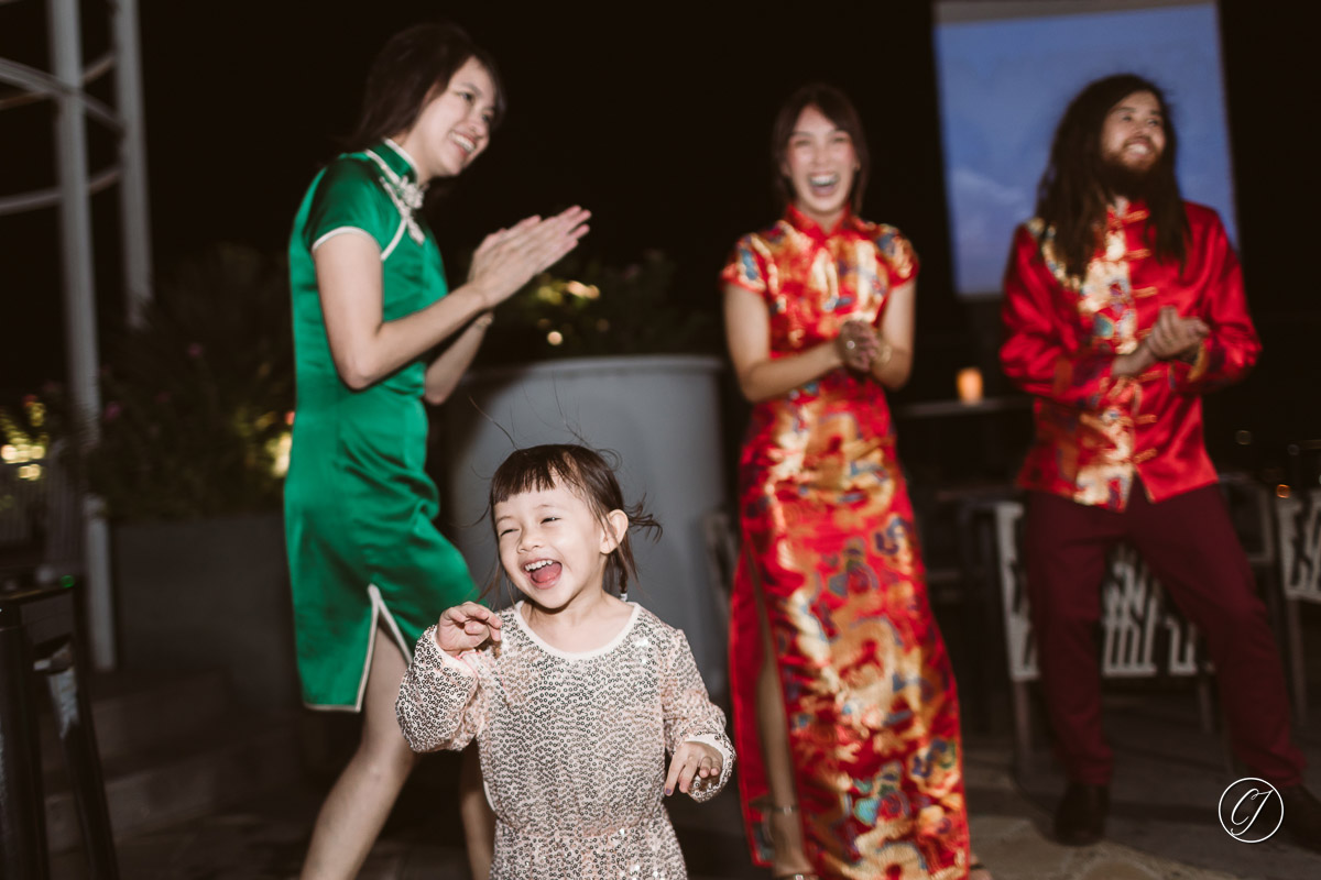 Little girl dancing with bride and groom