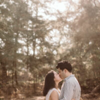 Gentle kiss with backlit in the woods